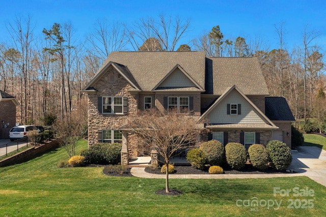 craftsman inspired home featuring stone siding, concrete driveway, a front lawn, and fence