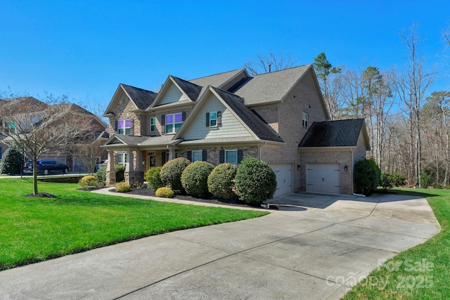 view of front of house with a garage, concrete driveway, a front lawn, and stone siding