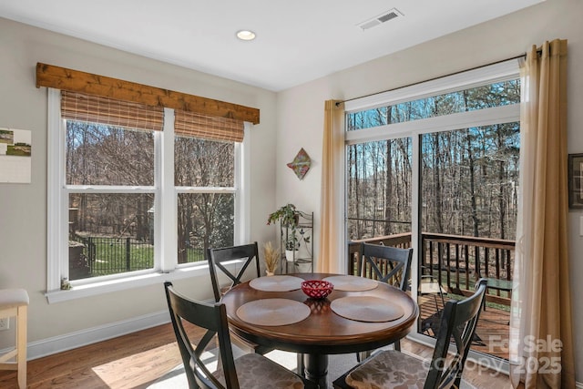 dining room with recessed lighting, visible vents, baseboards, and wood finished floors