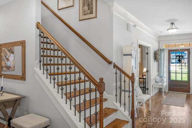 entryway featuring crown molding and wood finished floors