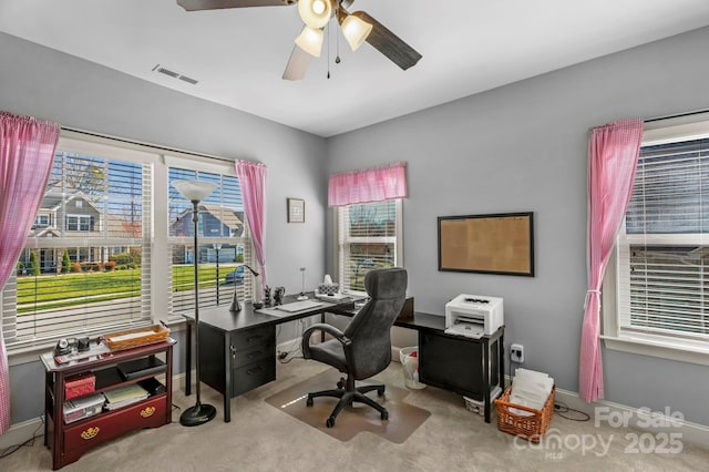 home office featuring visible vents, carpet floors, baseboards, and ceiling fan