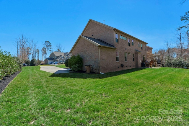 exterior space featuring a lawn and brick siding