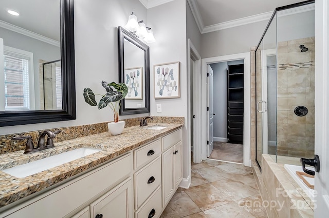 bathroom featuring crown molding, a walk in closet, and a sink