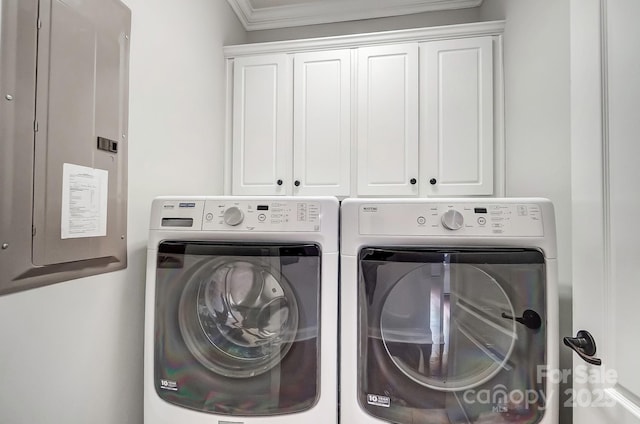 clothes washing area featuring ornamental molding, electric panel, cabinet space, and independent washer and dryer