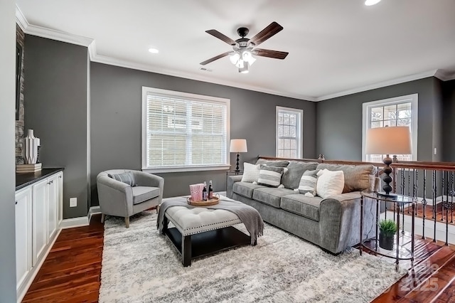 living room featuring dark wood-style floors, crown molding, and baseboards