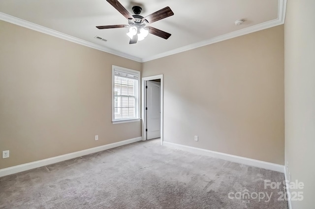 unfurnished room featuring baseboards, ornamental molding, visible vents, and light colored carpet