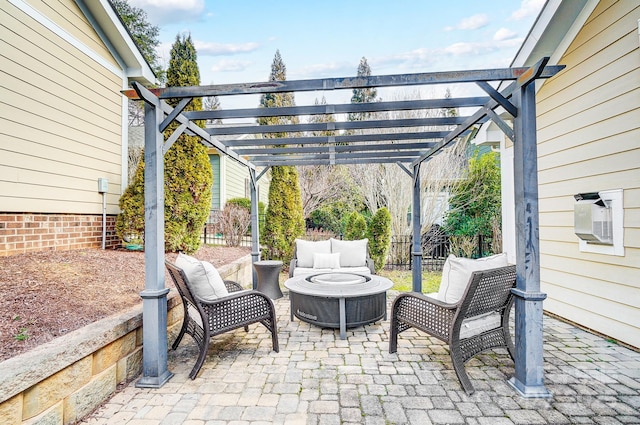 view of patio / terrace with fence, a fire pit, and a pergola