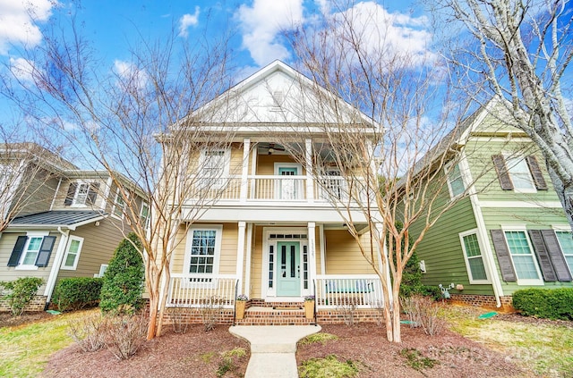 view of front of property with a balcony, covered porch, and ceiling fan