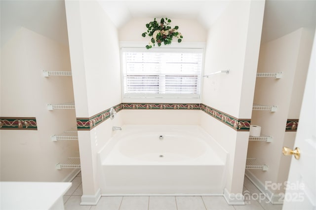 1 Carnoustie Ct, Campobello, SC 29322 - bathroom with vaulted ceiling, a tub, and tile patterned floors