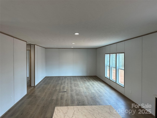 unfurnished room with dark hardwood / wood-style flooring