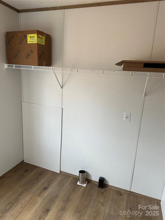 clothes washing area featuring hardwood / wood-style floors