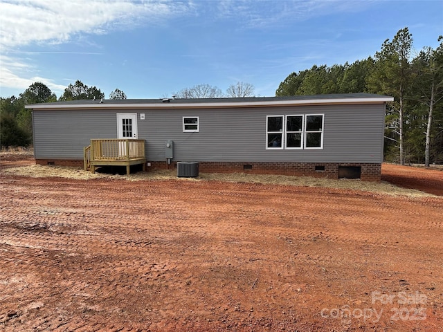 back of property featuring central AC unit and a deck