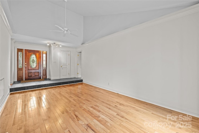 empty room with ceiling fan, high vaulted ceiling, ornamental molding, and light wood-type flooring