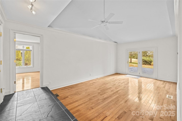 unfurnished living room with hardwood / wood-style flooring, vaulted ceiling, and ceiling fan