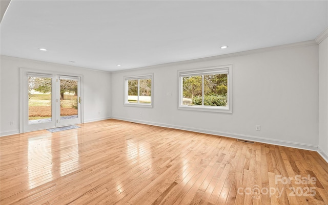 spare room with crown molding and light hardwood / wood-style flooring