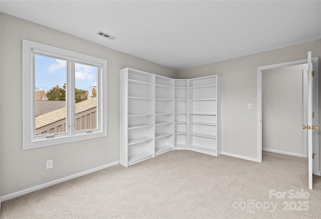 empty room featuring light colored carpet