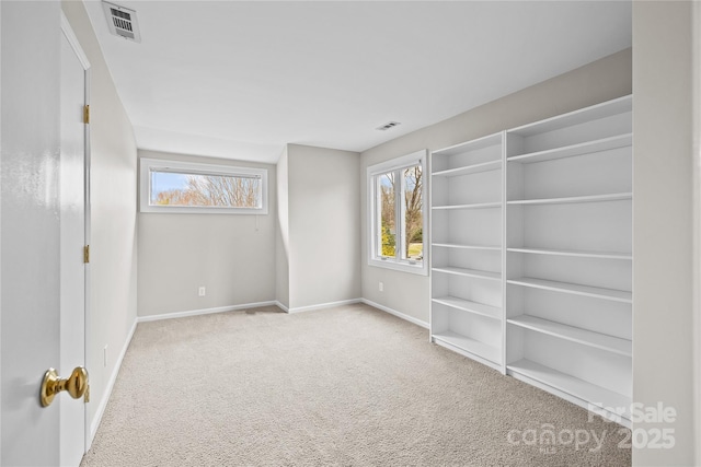 spare room featuring light colored carpet