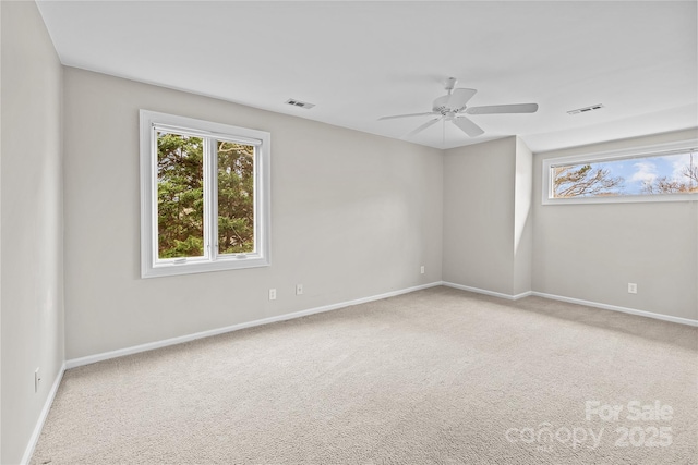 carpeted empty room featuring ceiling fan