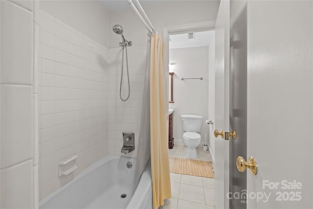 full bathroom featuring toilet, vanity, tile patterned floors, and shower / bath combo with shower curtain