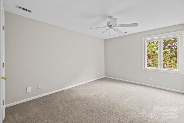 carpeted spare room featuring ceiling fan