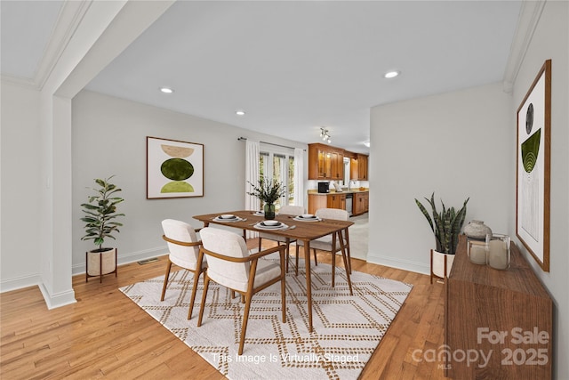 dining space with light hardwood / wood-style flooring