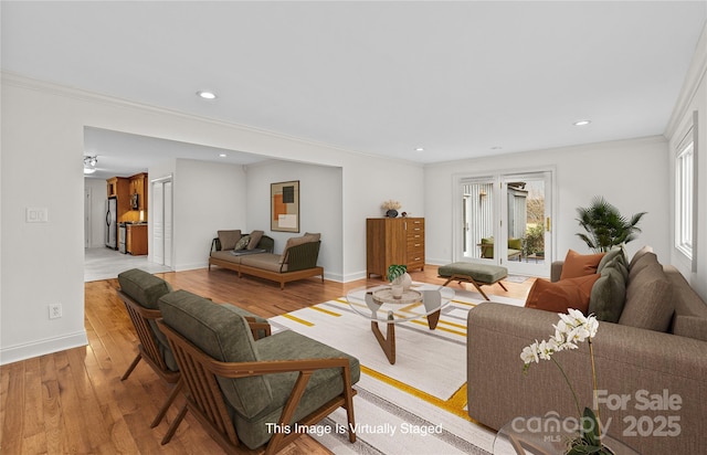 living room featuring ornamental molding and light hardwood / wood-style floors