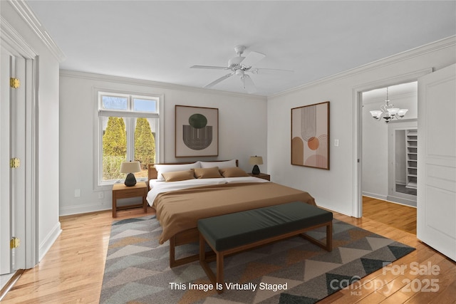 bedroom with crown molding and light hardwood / wood-style floors