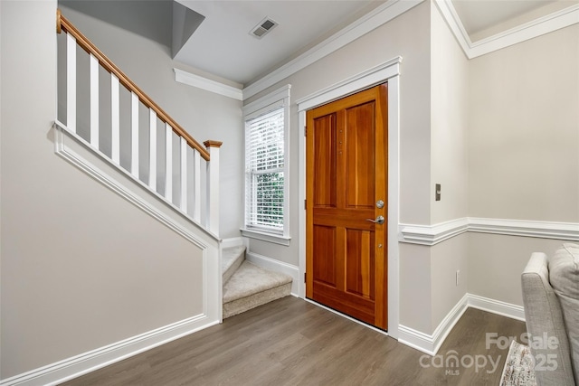 foyer entrance featuring crown molding and wood-type flooring