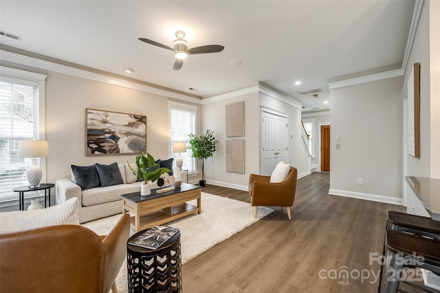 living room with ornamental molding and wood-type flooring