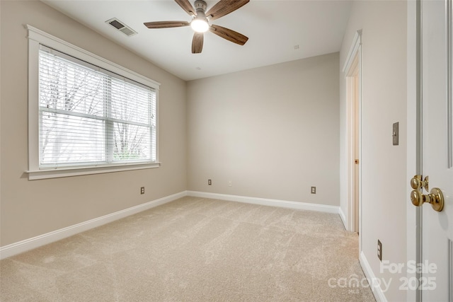 carpeted spare room with ceiling fan