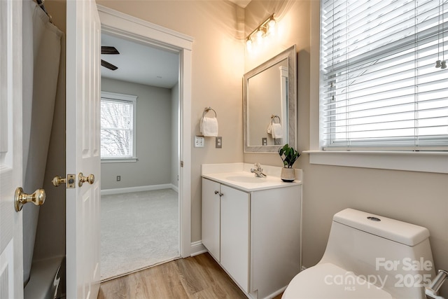 bathroom featuring vanity, hardwood / wood-style floors, and toilet