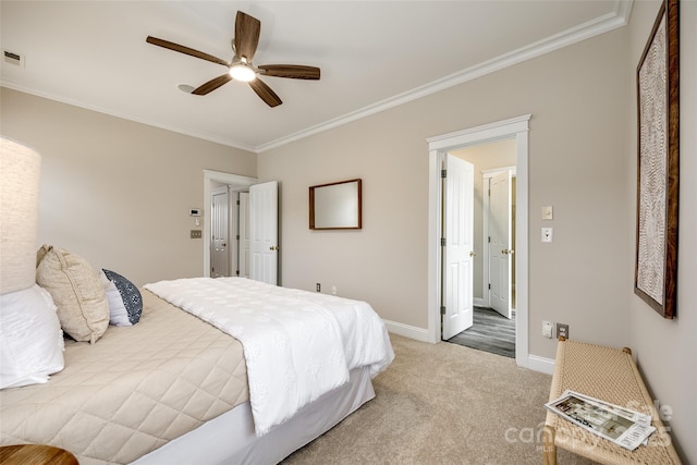 bedroom featuring ornamental molding, ceiling fan, and carpet