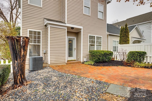 property entrance featuring central air condition unit and a patio area