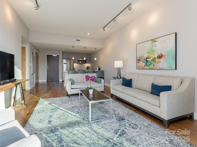 45 Asheland Ave Unit 302, Asheville, NC 28801 - living room featuring rail lighting and hardwood / wood-style floors