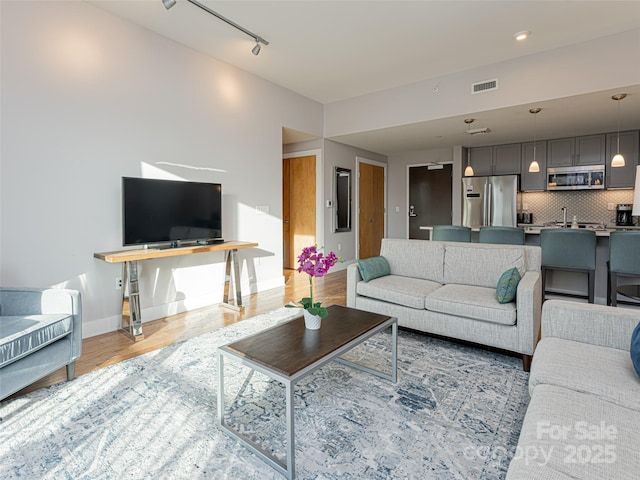 45 Asheland Ave Unit 302, Asheville, NC 28801 - living room with rail lighting and light wood-type flooring