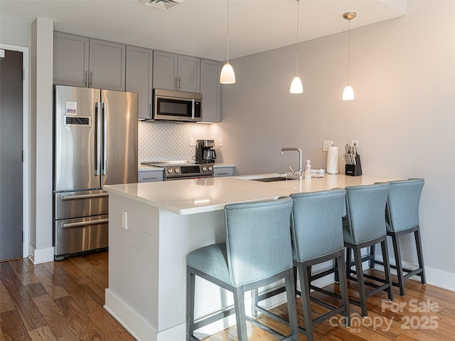 45 Asheland Ave Unit 302, Asheville, NC 28801 - kitchen featuring pendant lighting, sink, stainless steel appliances, dark hardwood / wood-style floors, and kitchen peninsula