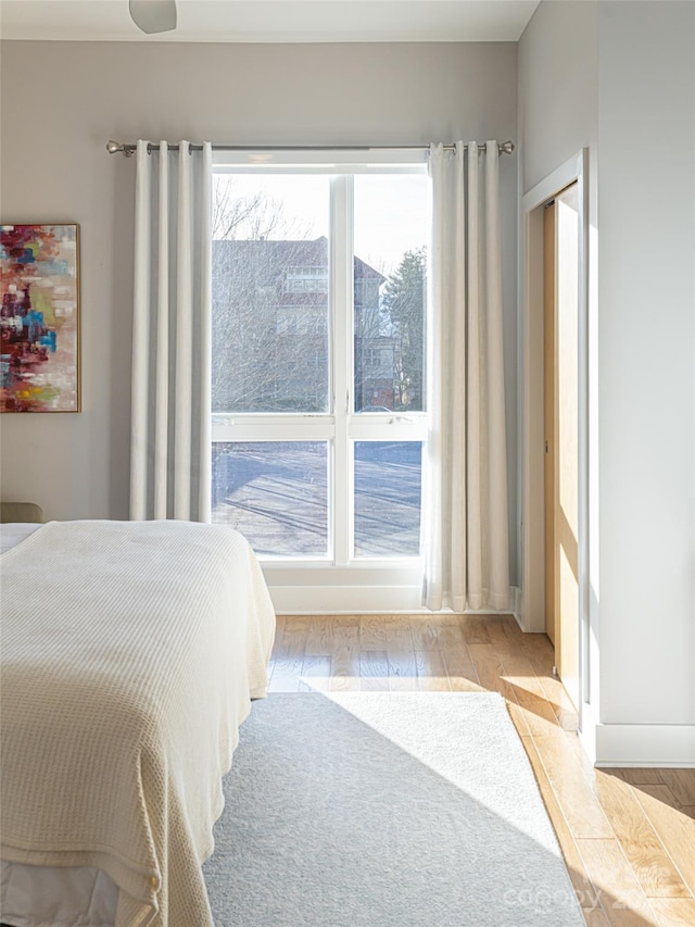 45 Asheland Ave Unit 302, Asheville, NC 28801 - bedroom featuring multiple windows and light hardwood / wood-style floors