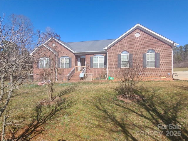 single story home with brick siding and a front lawn