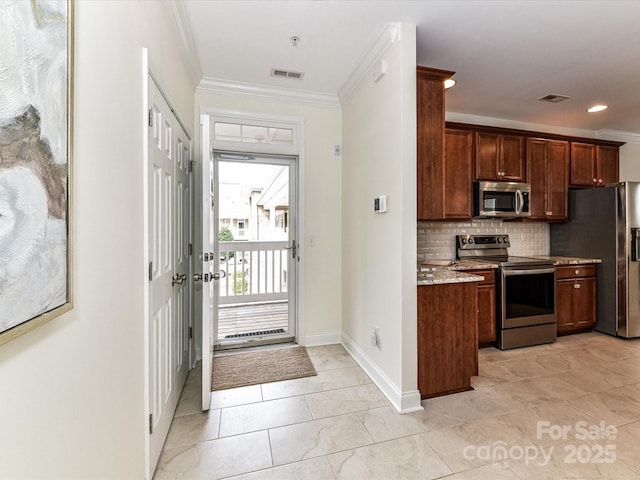 kitchen featuring appliances with stainless steel finishes, ornamental molding, tasteful backsplash, and light stone countertops