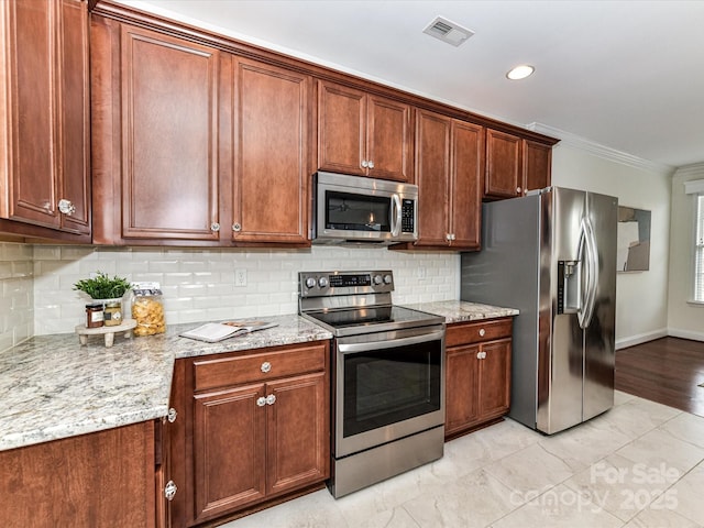 kitchen with light stone countertops, backsplash, crown molding, and stainless steel appliances