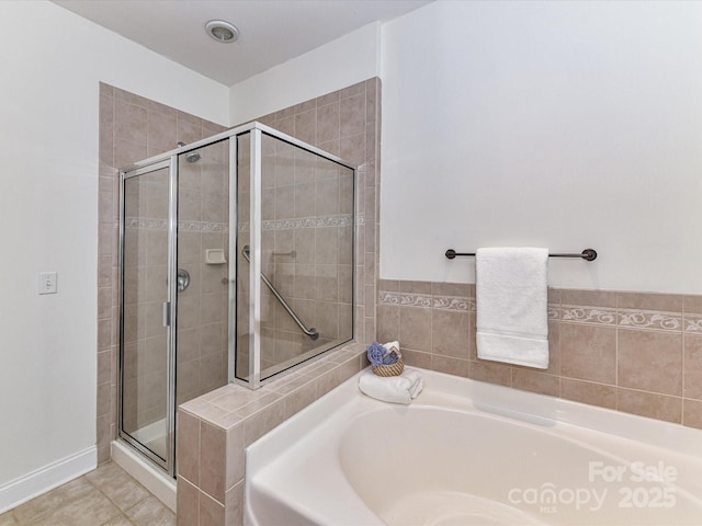 bathroom with tile patterned flooring and independent shower and bath