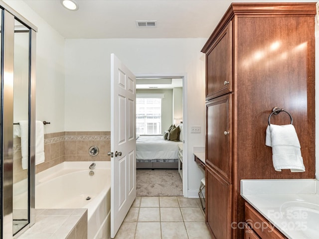 bathroom with a tub, tile patterned flooring, and vanity