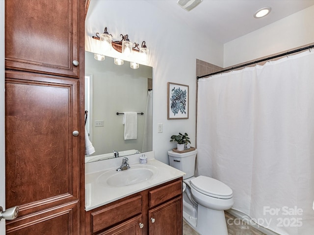 bathroom with toilet and vanity