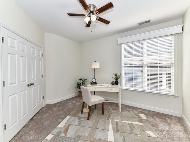 office space featuring ceiling fan and light colored carpet