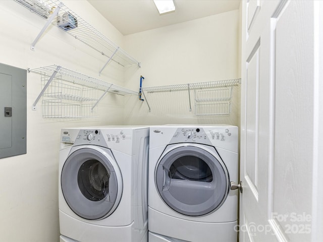 washroom featuring electric panel and washer and dryer