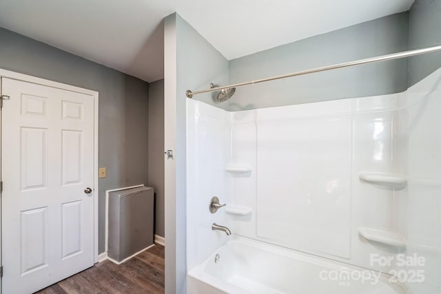 bathroom with wood-type flooring and  shower combination