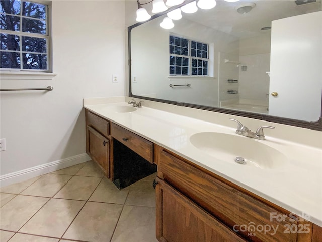 full bath with double vanity, tile patterned flooring, tub / shower combination, and a sink