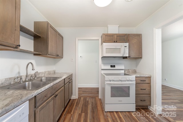 kitchen with dark wood finished floors, open shelves, a sink, light countertops, and white appliances