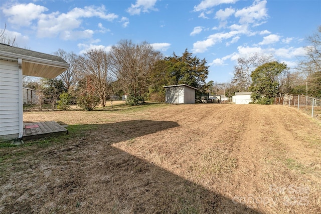 view of yard with fence and a shed