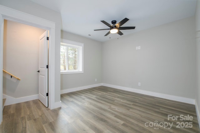 empty room featuring wood-type flooring and ceiling fan